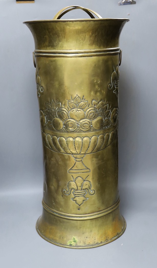 An embossed brass stick stand, 66cms high.